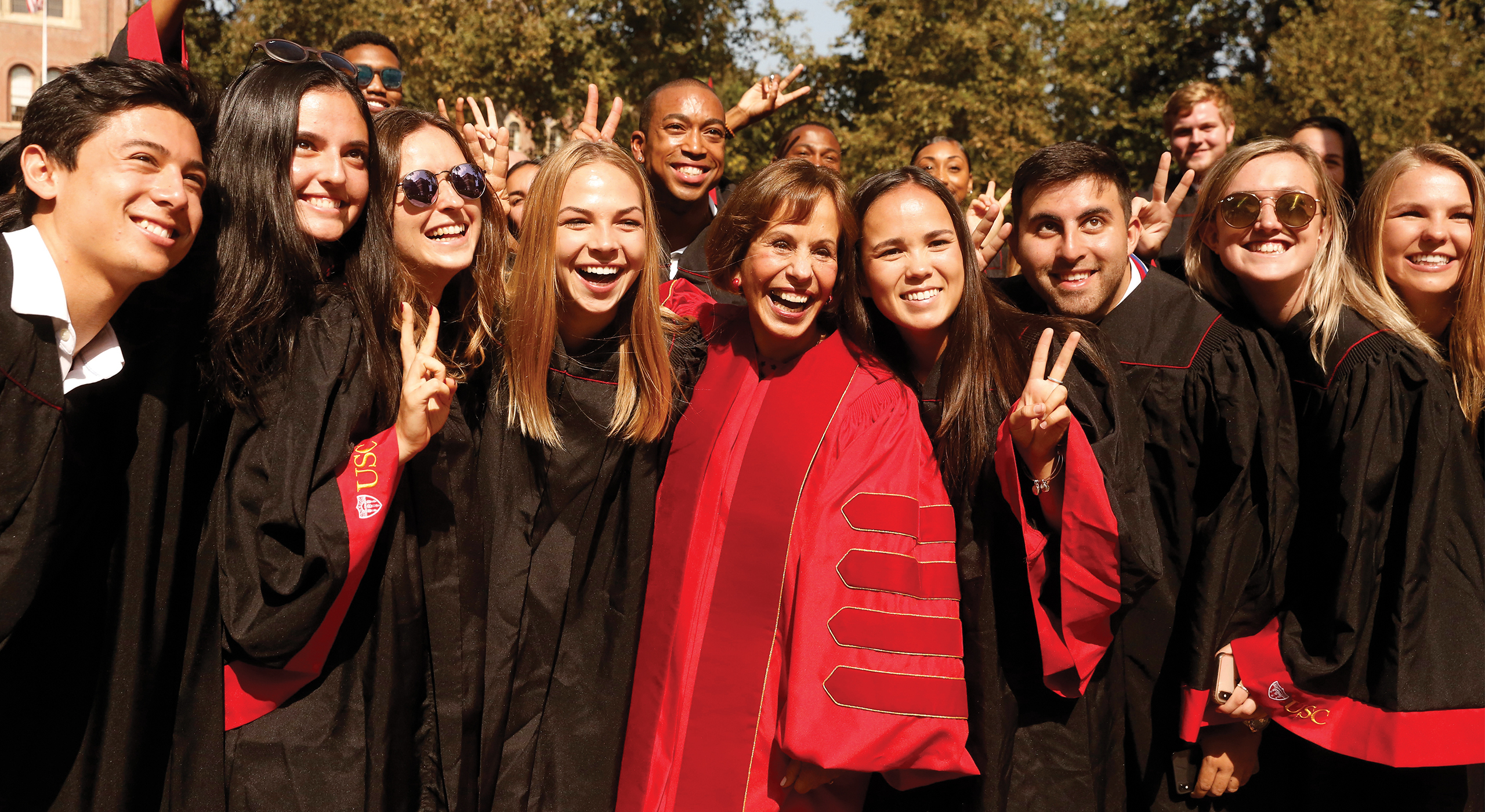 USC President Carol Folt with a group of students at Commencement